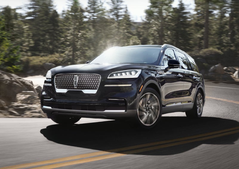 A Lincoln Aviator® SUV is being driven on a winding mountain road | Lincoln Demo 3 in Wooster OH