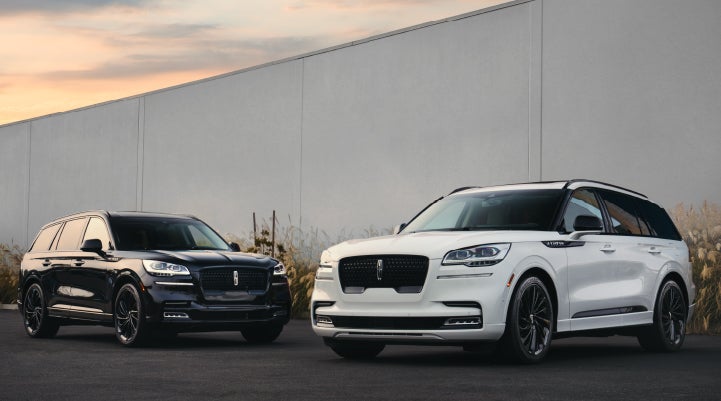 Two Lincoln Aviator® SUVs are shown with the available Jet Appearance Package | Lincoln Demo 3 in Wooster OH