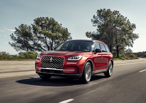 A 2024 Lincoln Corsair® SUV is shown being driven on a country road. | Lincoln Demo 3 in Wooster OH