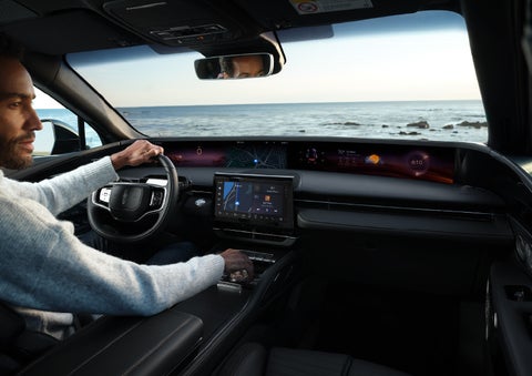 A driver of a parked 2024 Lincoln Nautilus® SUV takes a relaxing moment at a seaside overlook while inside his Nautilus. | Lincoln Demo 3 in Wooster OH
