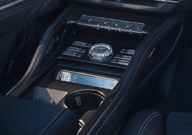 A smartphone is shown charging in the wireless charging pad. | Lincoln Demo 3 in Wooster OH